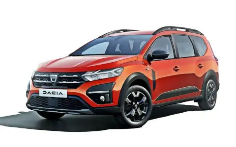 Pomarańczowy Dacia Jogger, marka samochodu na d, z relingami dachowymi i czarnymi felgami.